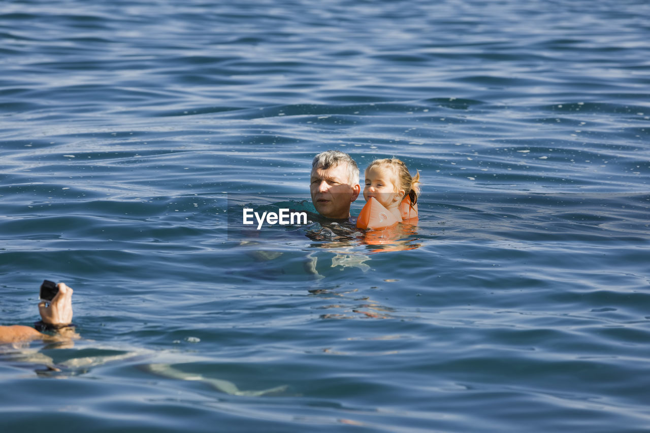 MAN SWIMMING IN SEA