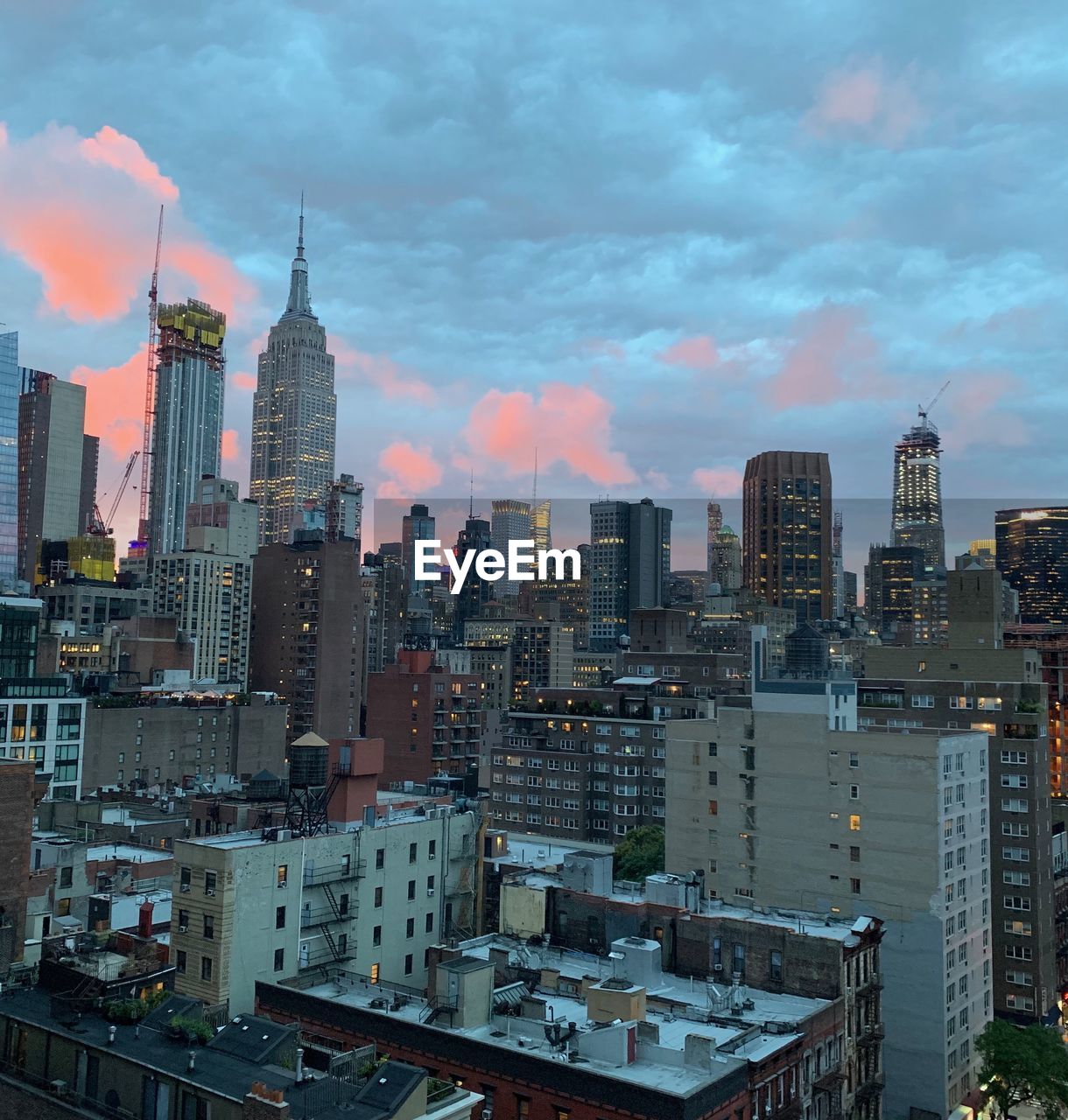 Aerial view of buildings in city against sky