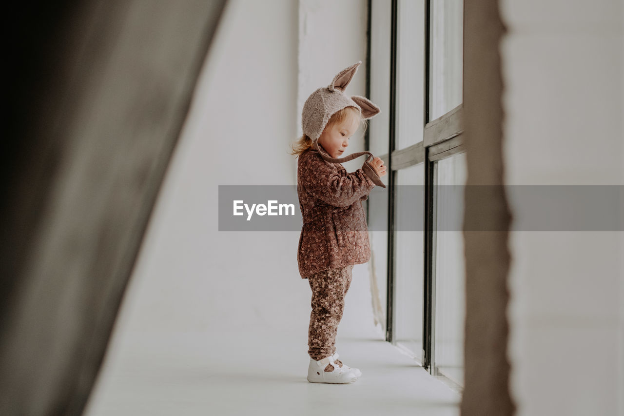 Toddler baby girl in funny hat with ears having fun