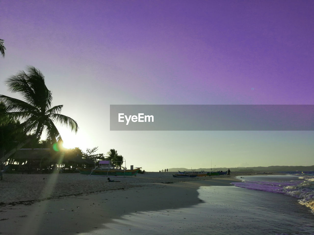 SCENIC VIEW OF BEACH AGAINST SKY AT SUNSET