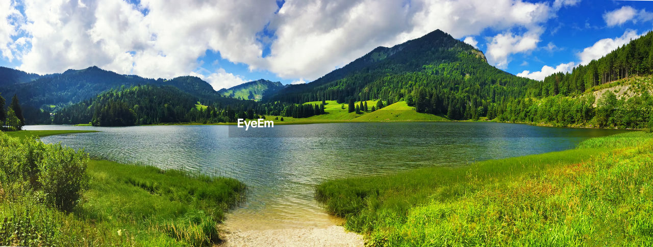 PANORAMIC VIEW OF LAKE BY MOUNTAINS AGAINST SKY