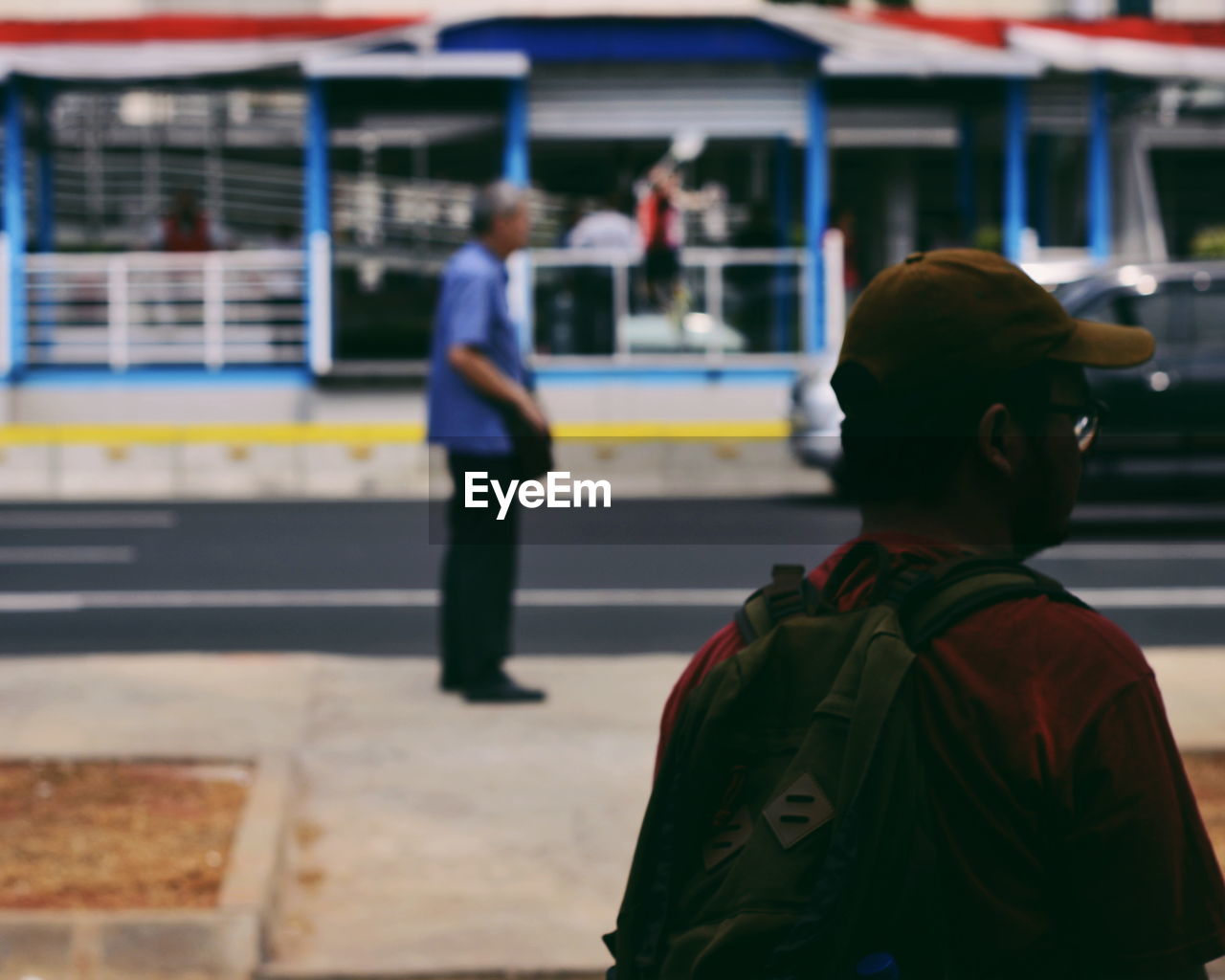 Man standing at railroad station platform