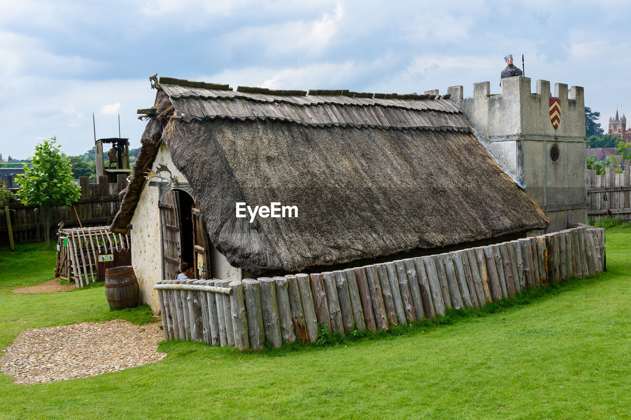 OLD WOODEN HOUSE ON FIELD
