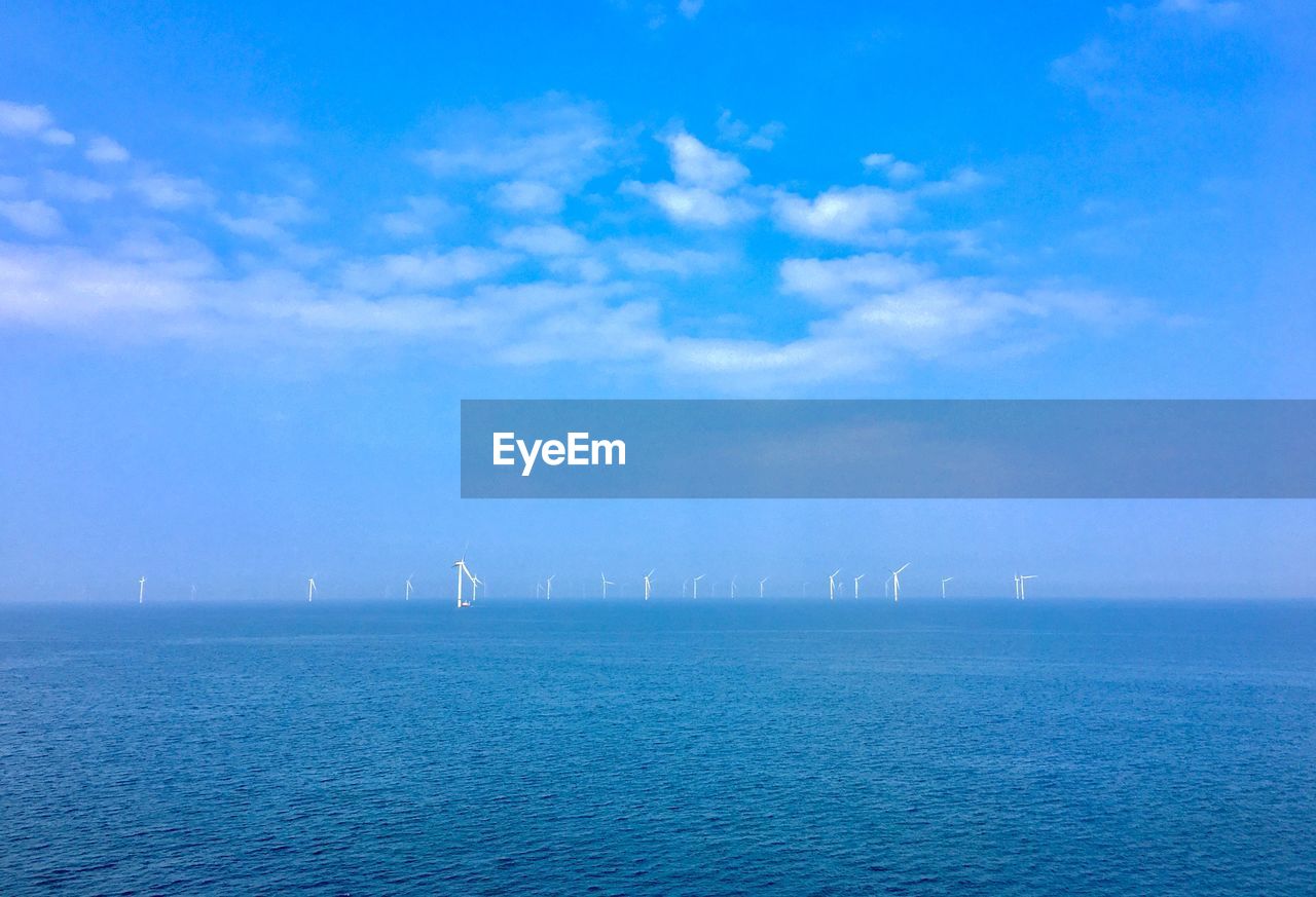 SAILBOAT IN SEA AGAINST BLUE SKY