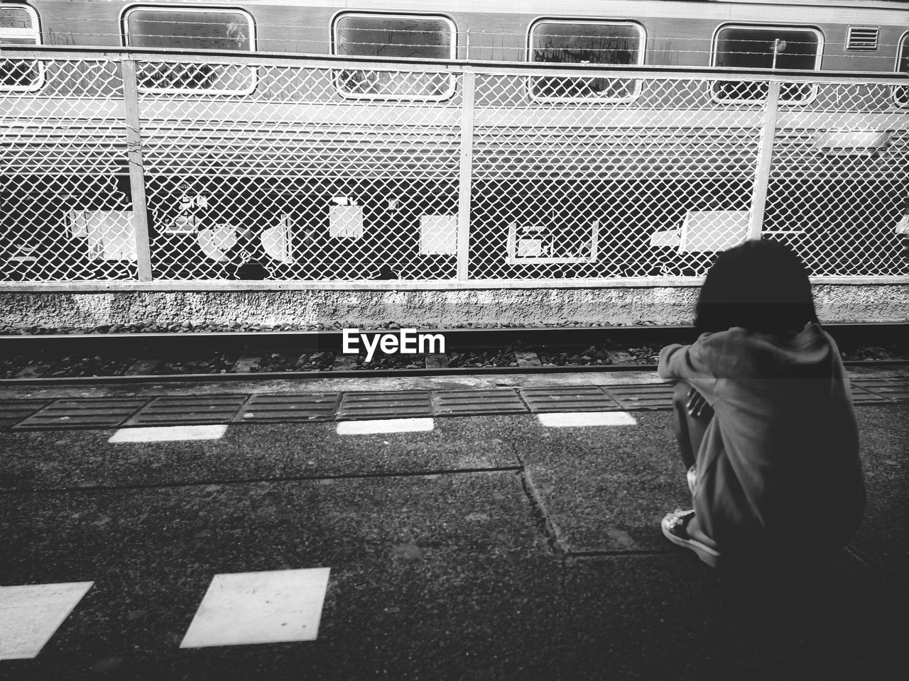 REAR VIEW OF WOMAN SITTING ON BUS