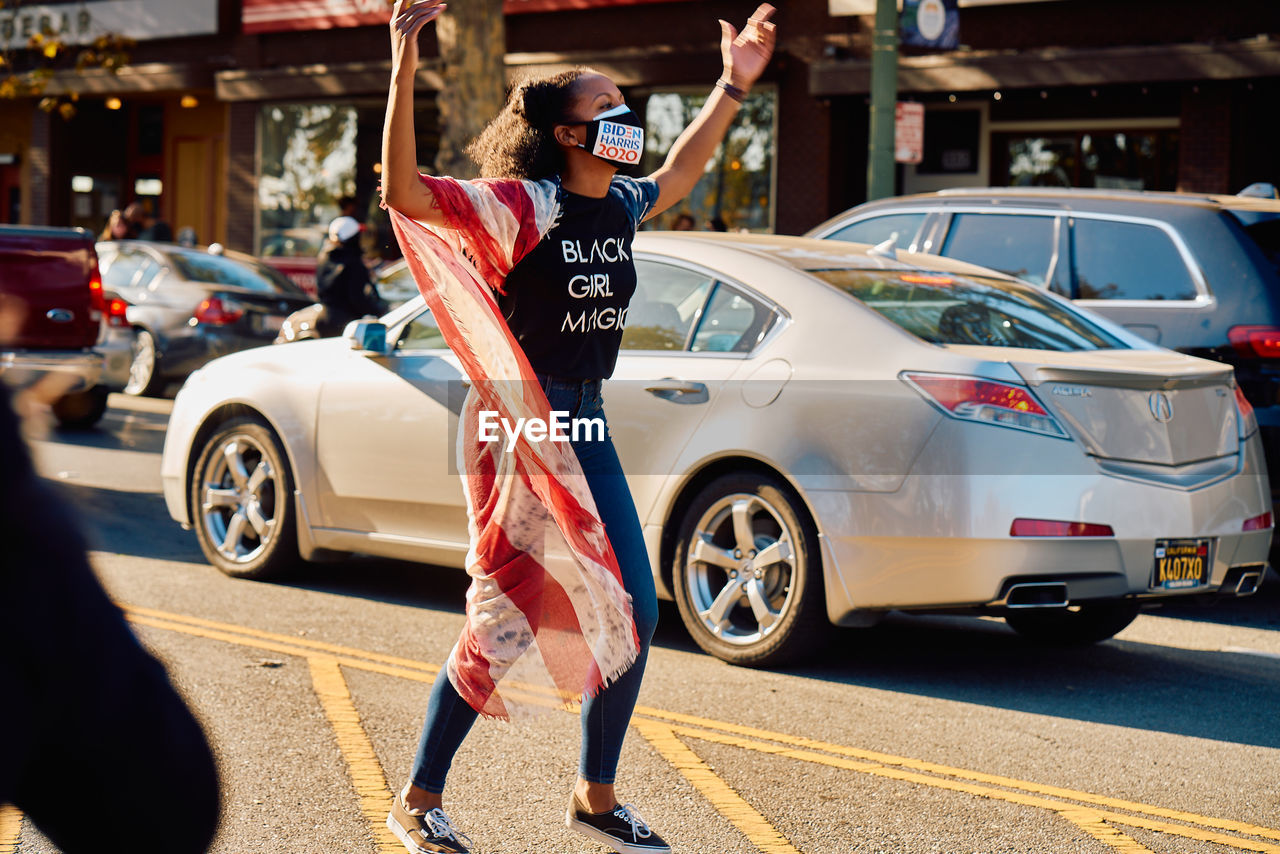 FULL LENGTH OF WOMAN STANDING ON ROAD