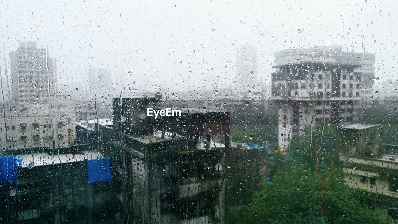 Buildings seen through wet window in rainy season