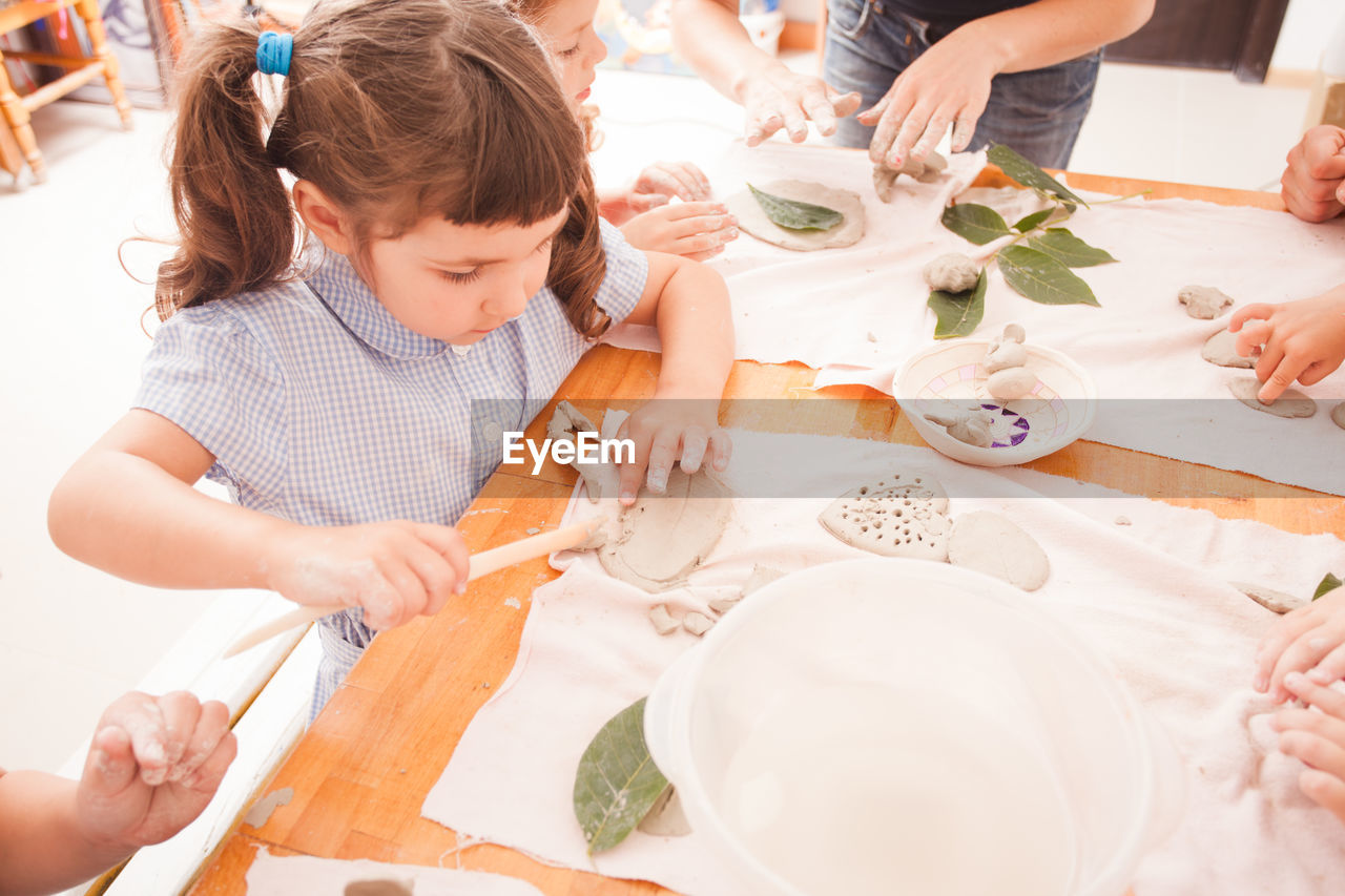 Students playing with clay at school