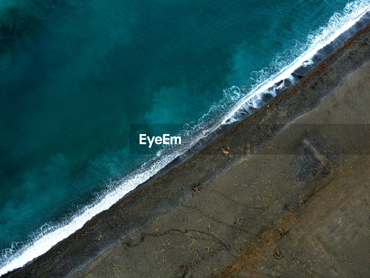 Green sea and brown beach