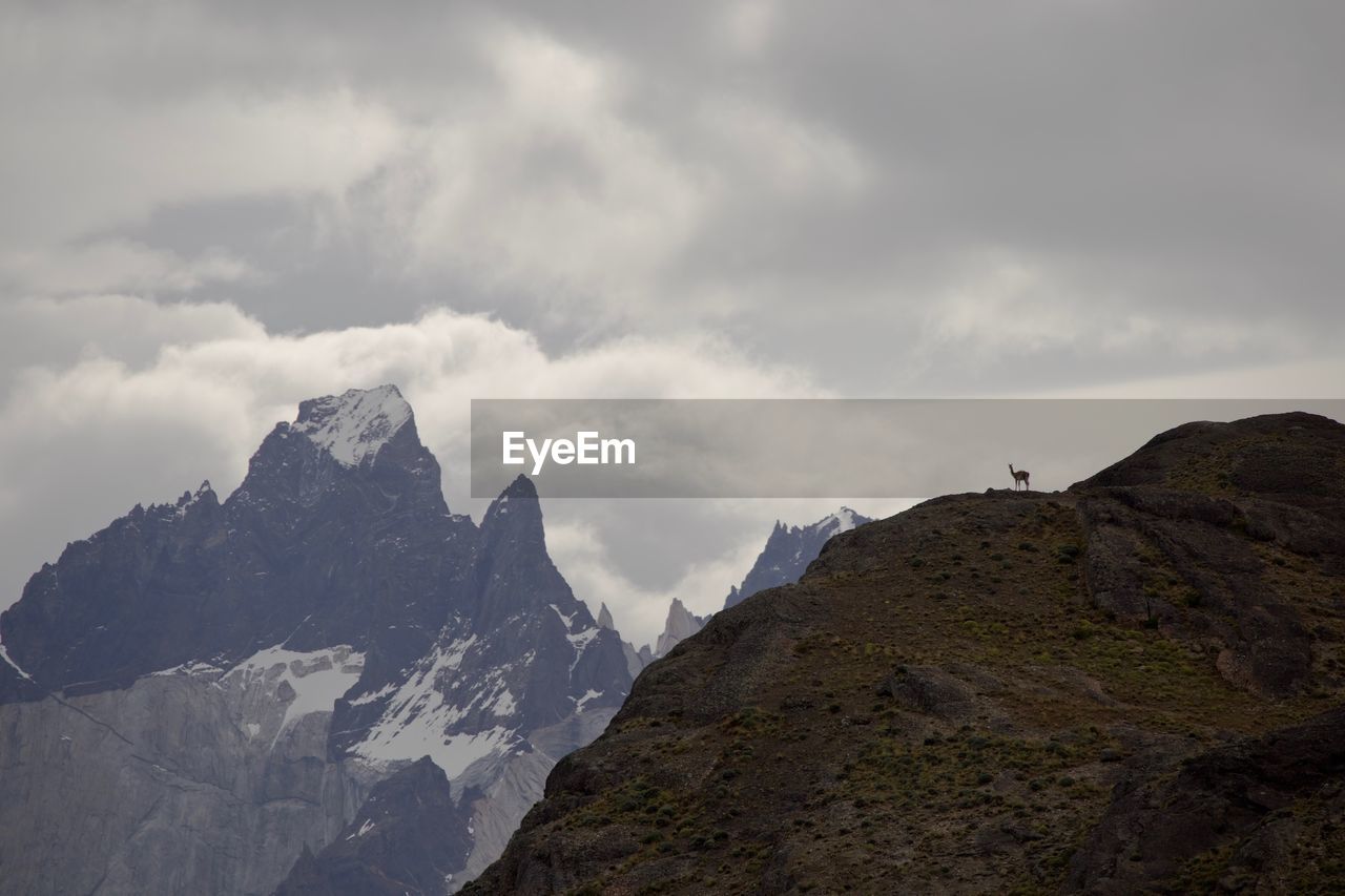 Scenic view of mountains against cloudy sky