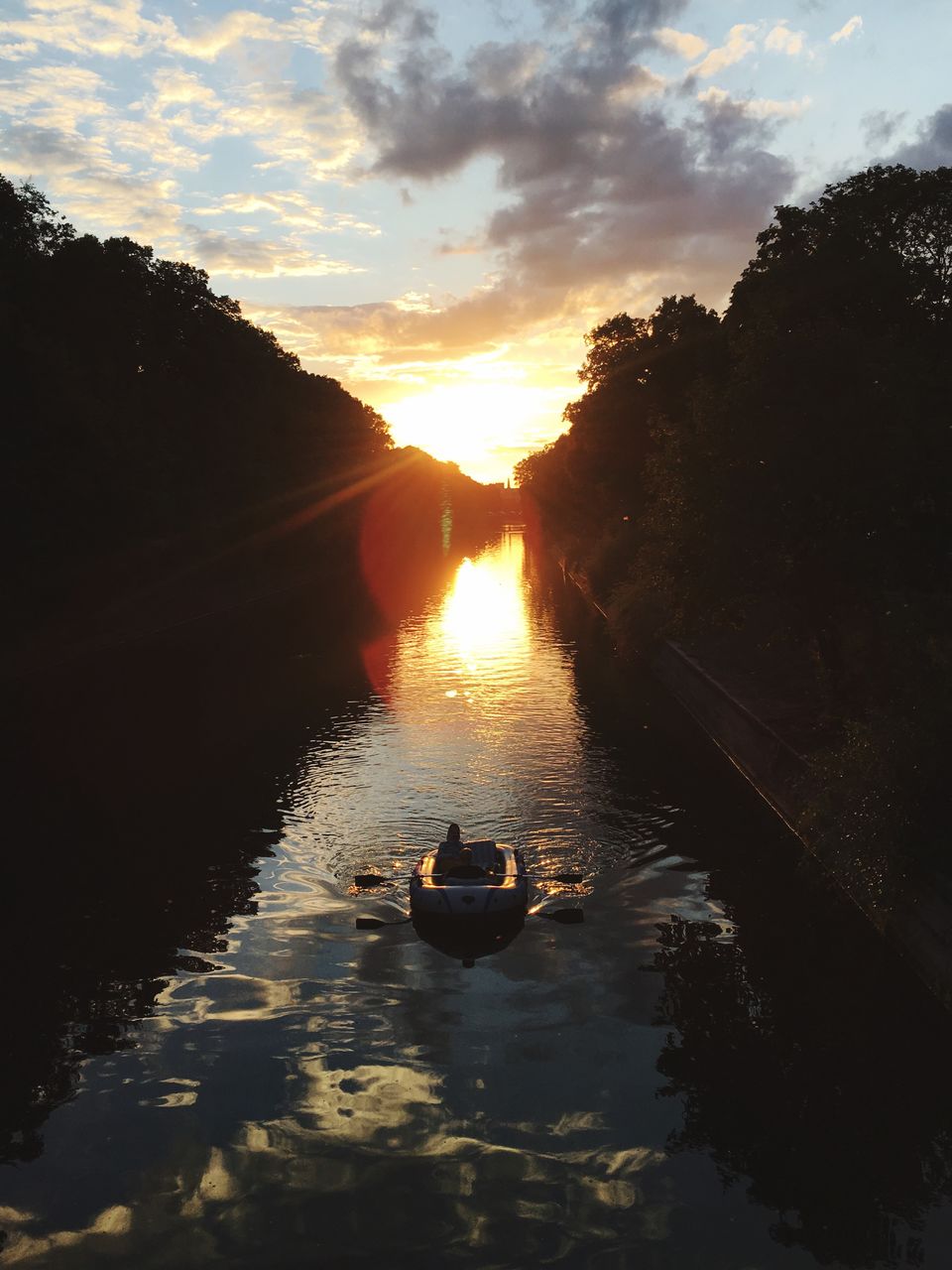 High angle view of people boating on river during sunset