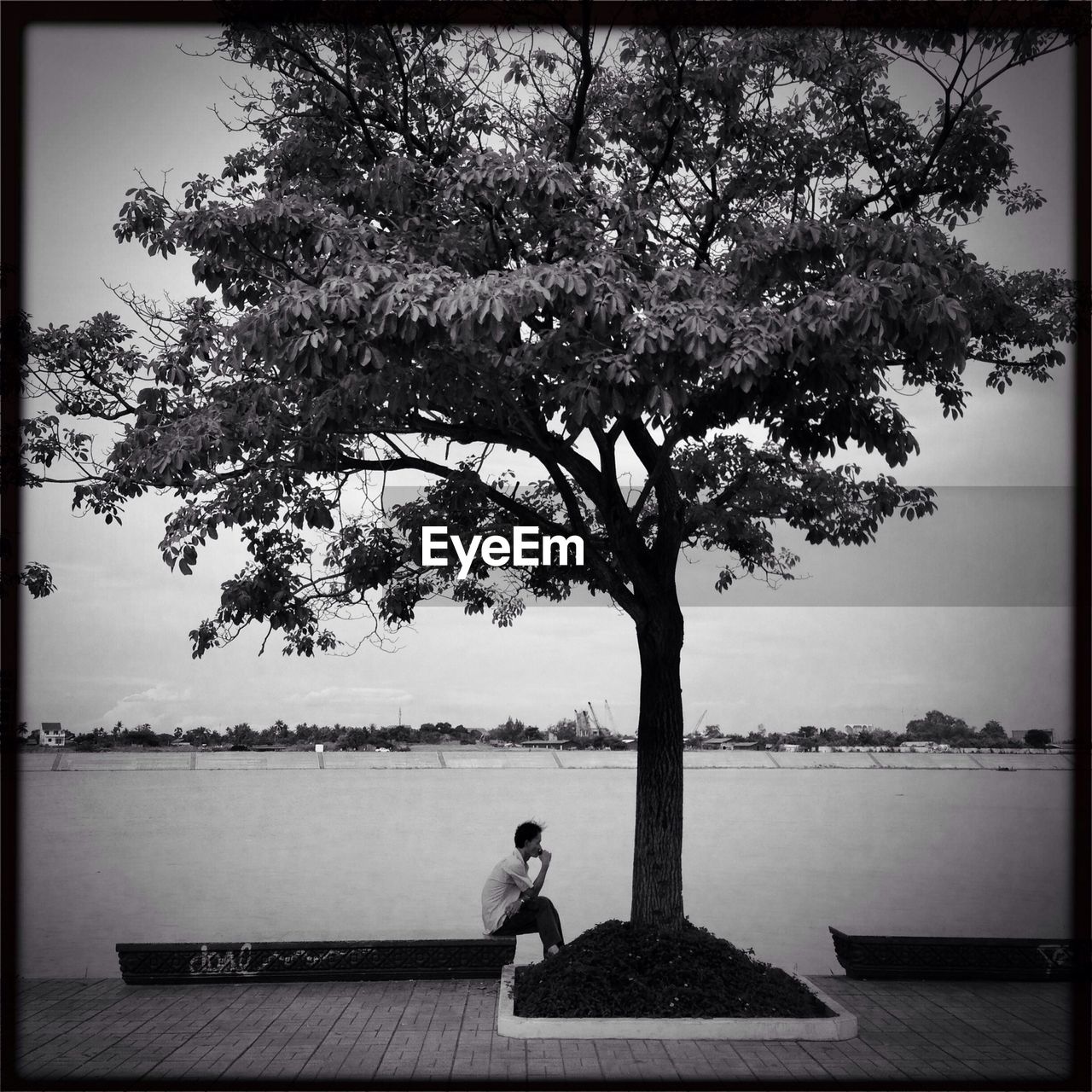 Man sitting on riverbank