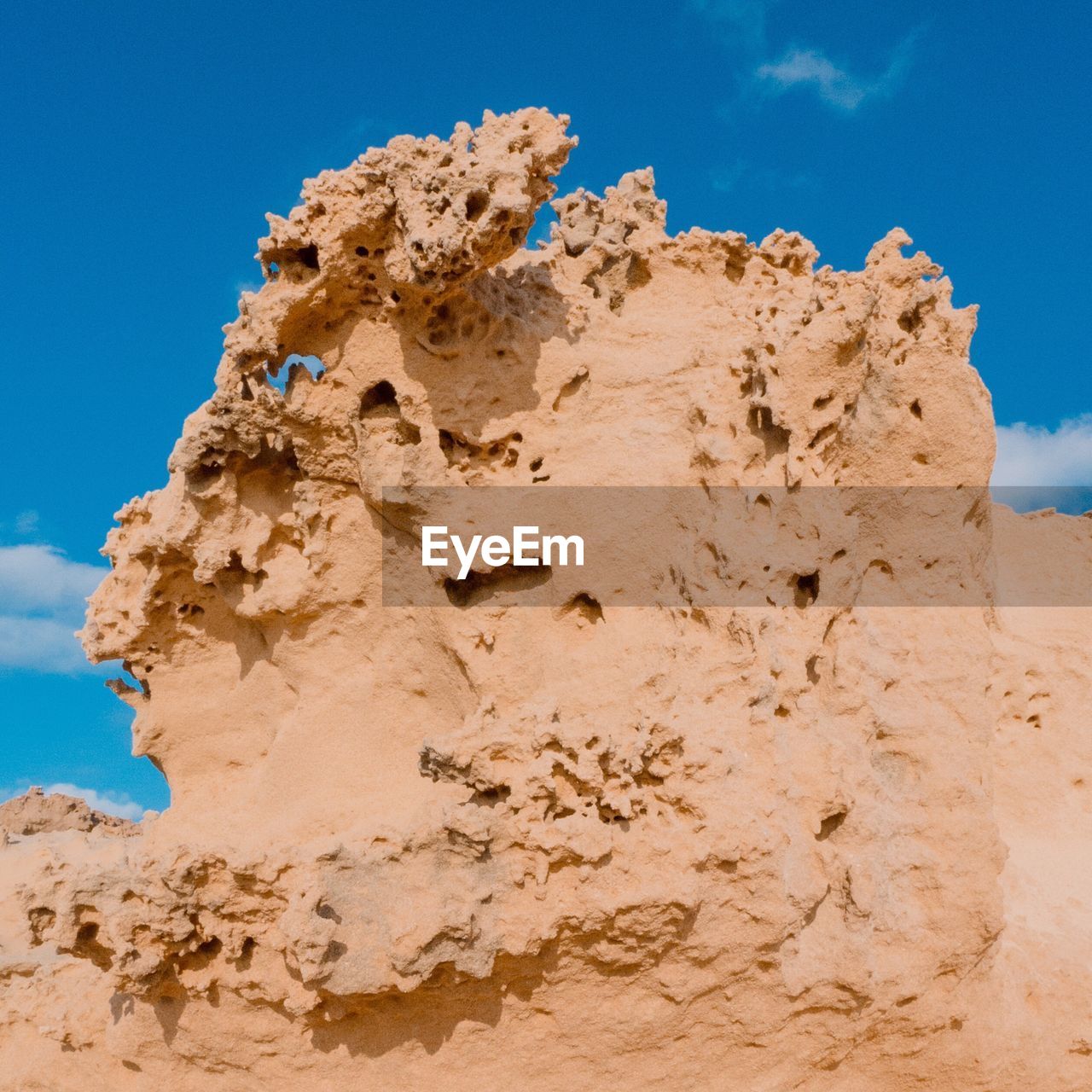 Low angle view of rock formation against sky