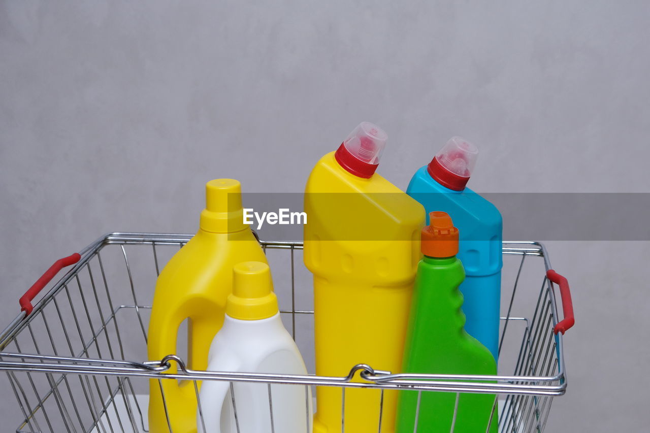 Purchase of household chemicals. different bottles of household chemicals in the shopping basket