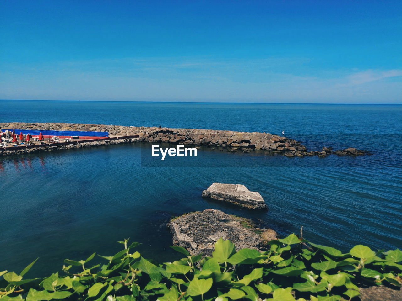 Scenic view of sea against blue sky