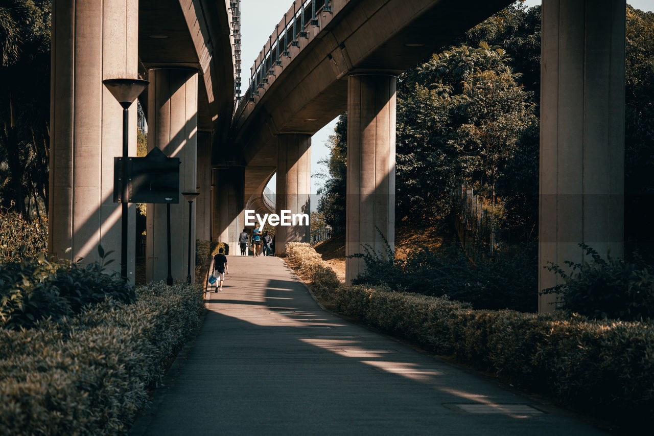 Bridge over empty road by buildings in city