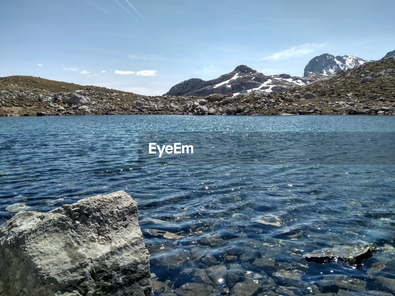 Scenic view of mountains and river against sky