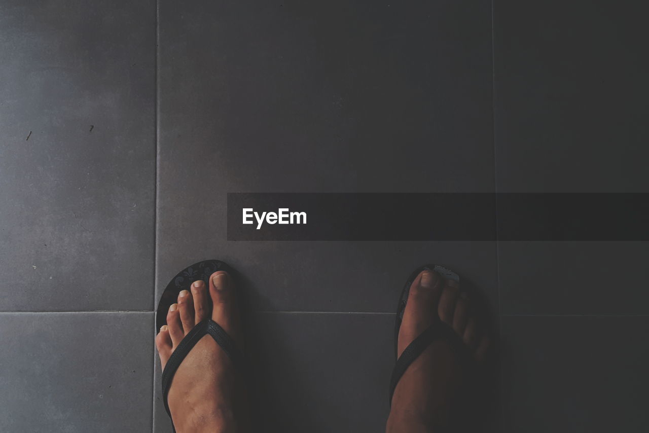 Low section of woman standing on floor