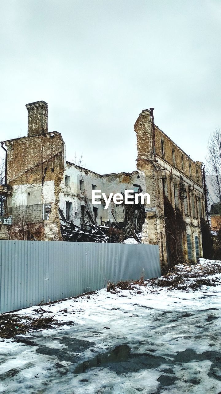 BUILT STRUCTURE IN WINTER AGAINST SKY