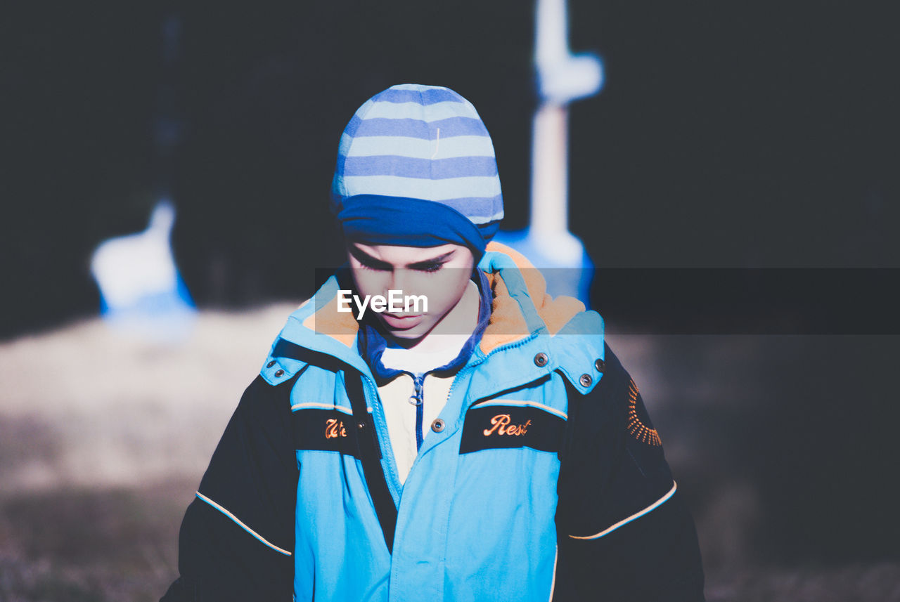 Boy wearing warm clothing on field