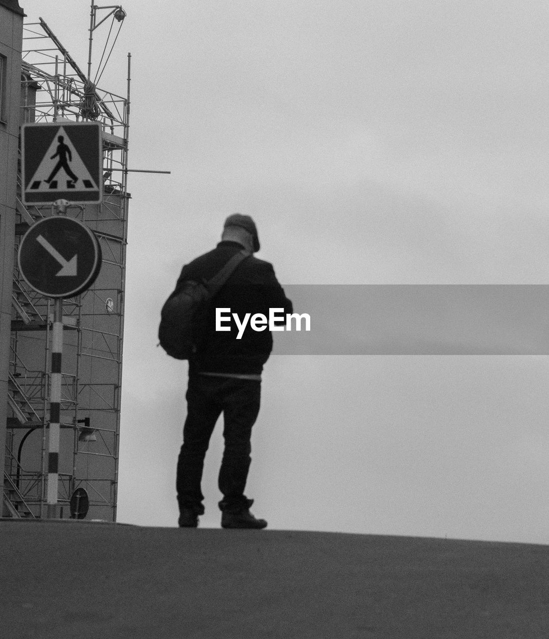 Rear view of man standing against sky