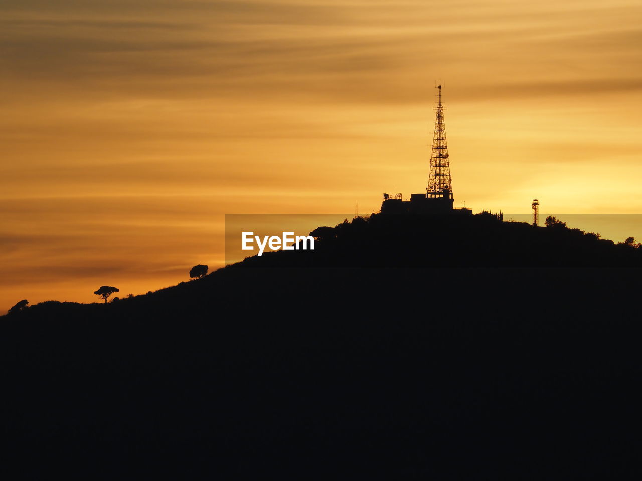 LOW ANGLE VIEW OF SILHOUETTE TOWER AGAINST SKY DURING SUNSET