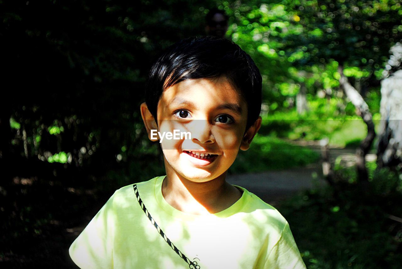 Portrait of smiling cute boy at park