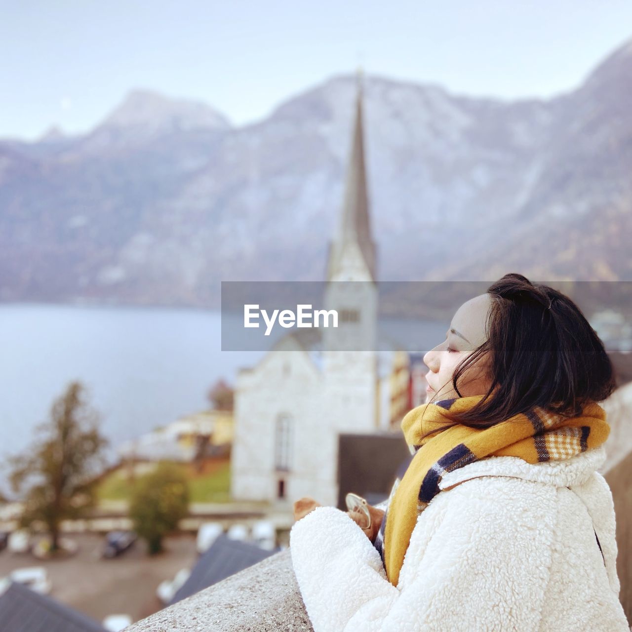 Side view of woman looking away against sky