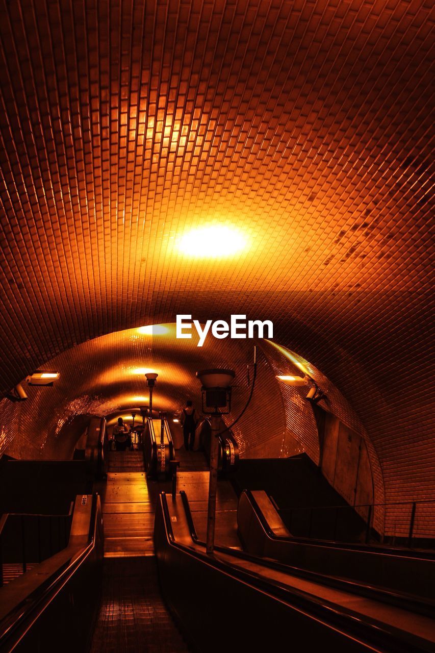 Illuminated tunnel at subway station