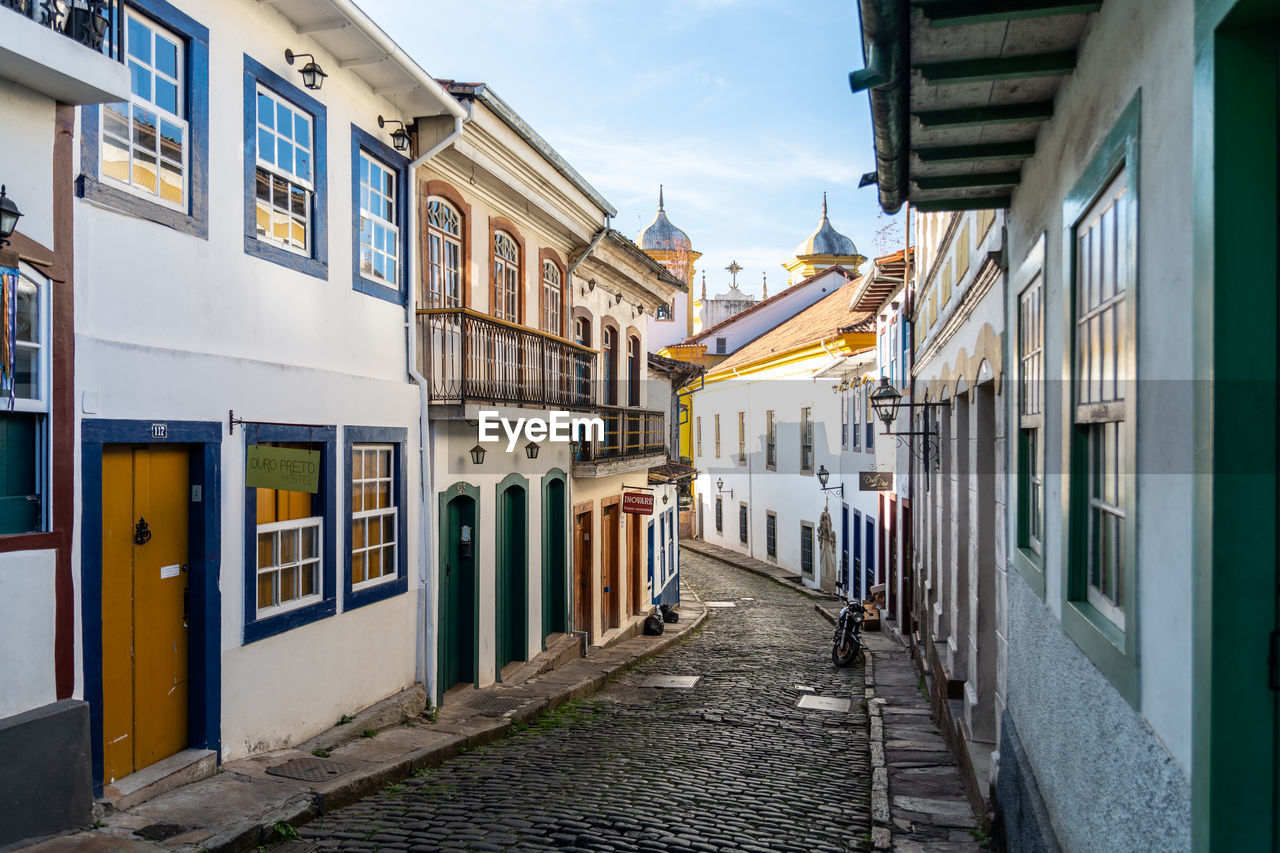 Empty street amidst buildings in city