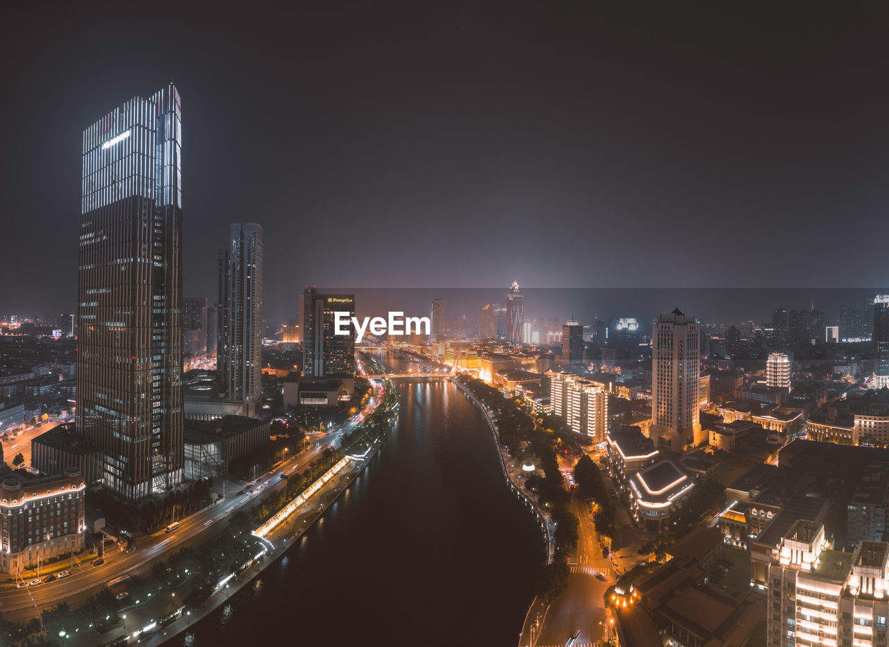 High angle view of illuminated city buildings at night