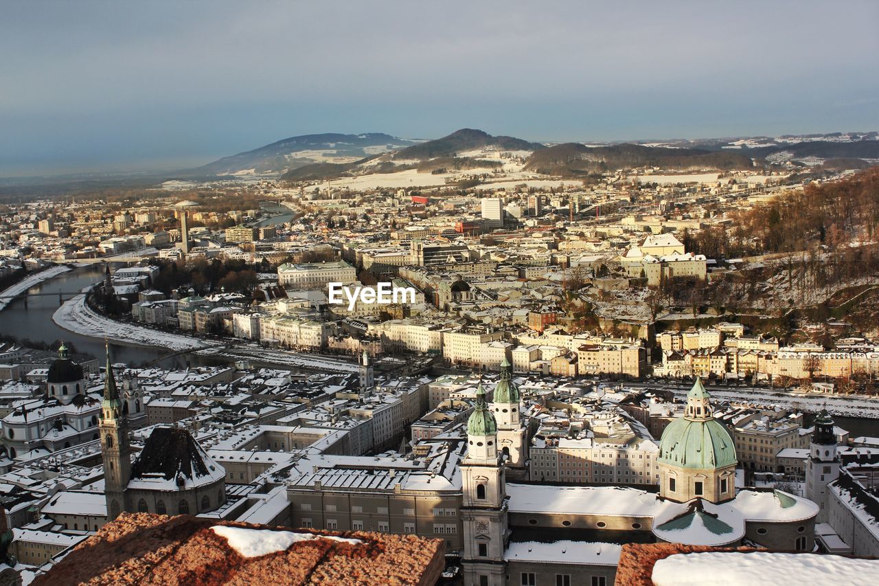 High angle view of snow covered karlskirche by buildings