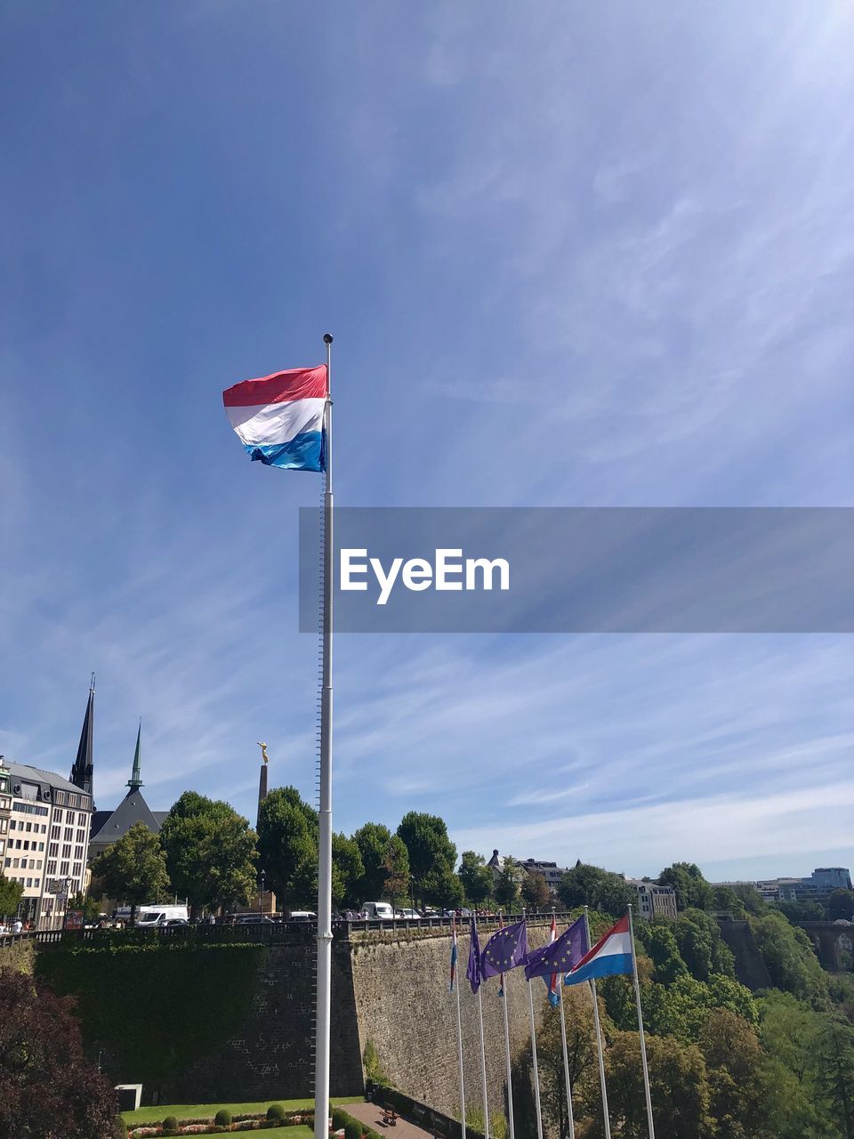 flag, sky, patriotism, nature, architecture, cloud, environment, built structure, day, no people, travel destinations, blue, pole, outdoors, tree, building exterior, travel, plant, city, wind, building, landscape, land