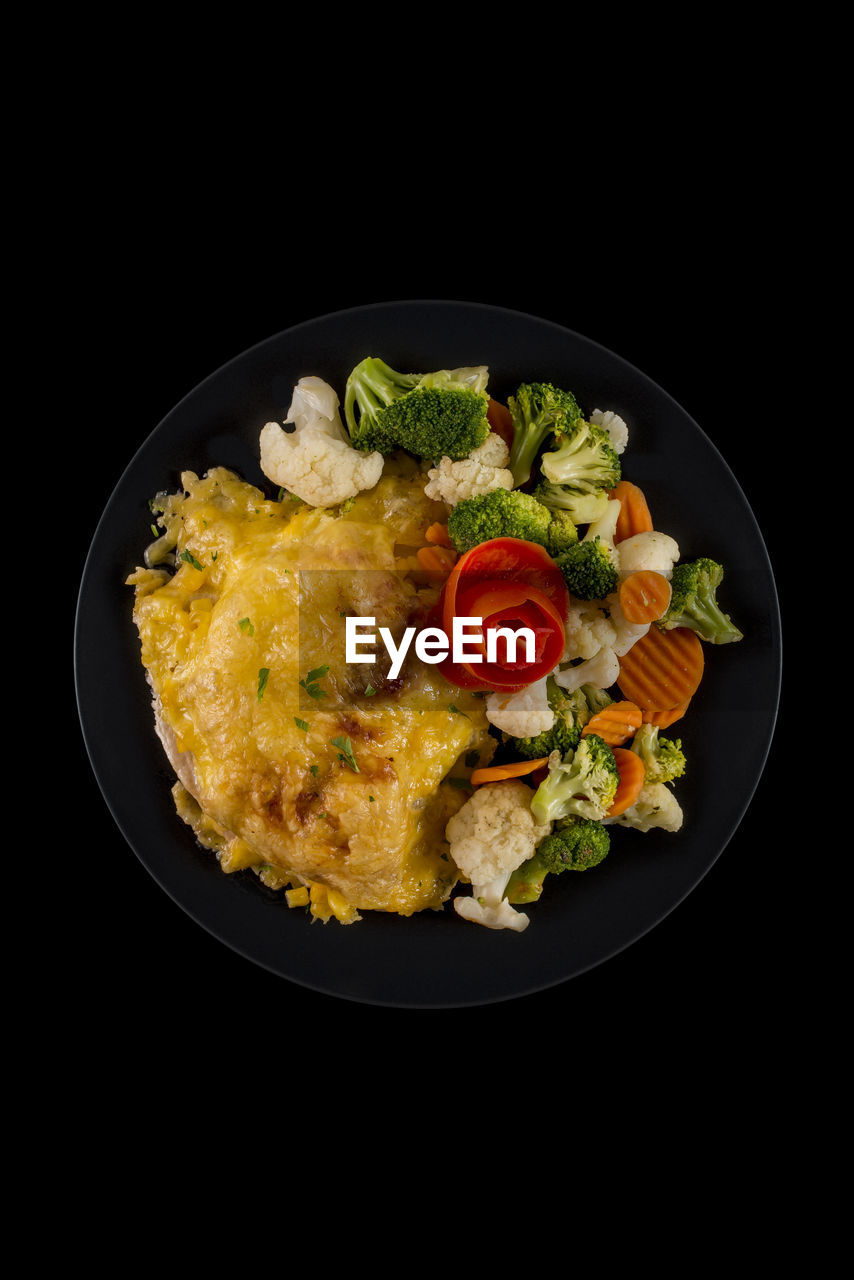 High angle view of food in plate over black background