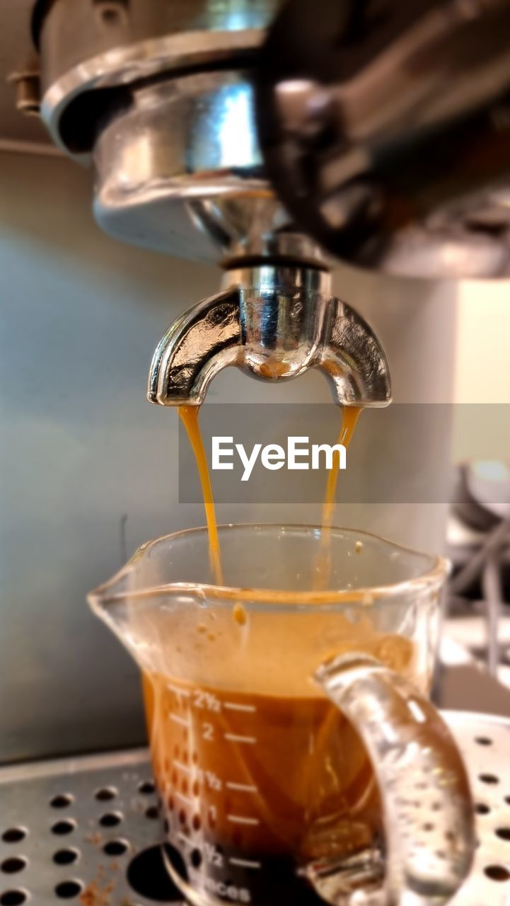 Close-up of coffee pouring into glass