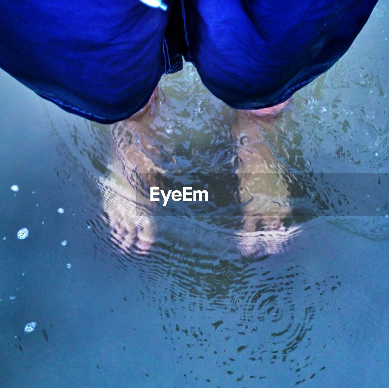 Man standing ankle-deep in water