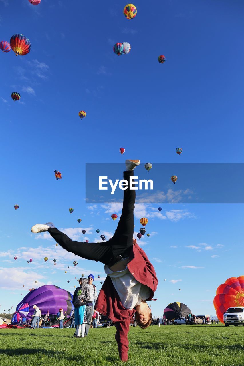 View of hot air balloons flying against blue sky