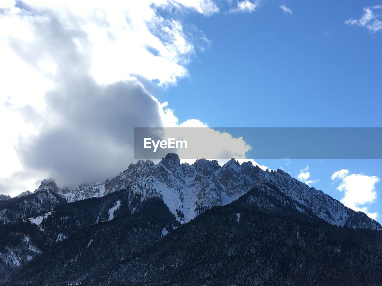 Low angle view of snowcapped mountains against sky