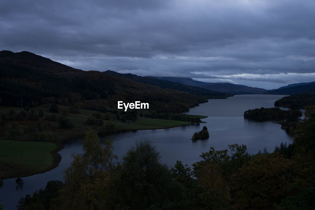 Scenic view of lake and mountains against sky