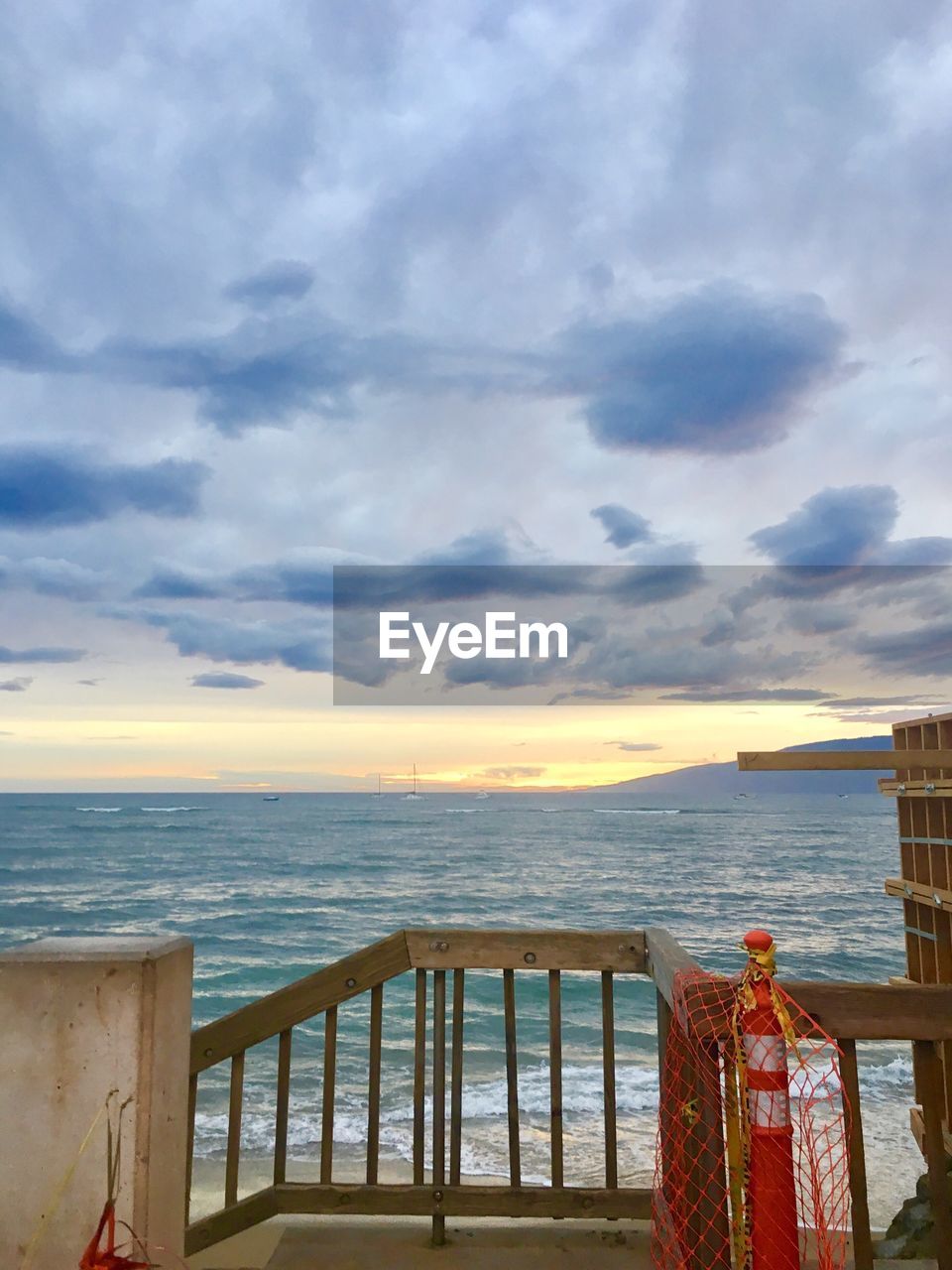 VIEW OF BEACH AGAINST CLOUDY SKY