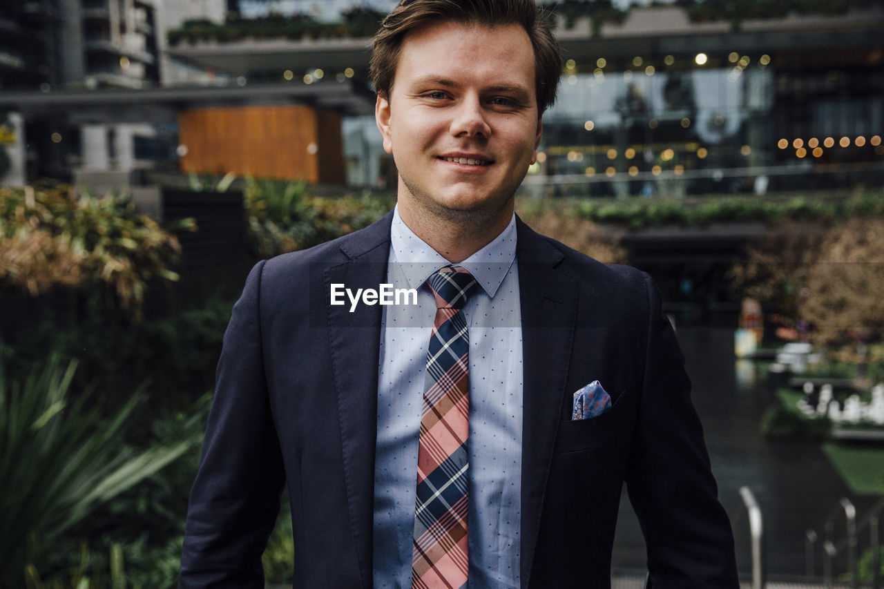 Portrait of confident businessman in city