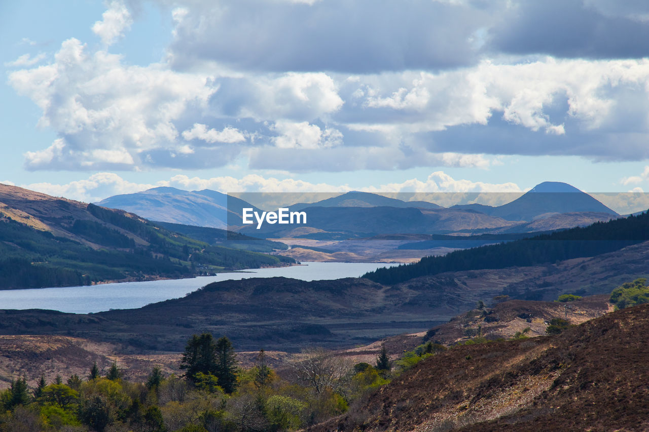 Scenic view of mountains against cloudy sky