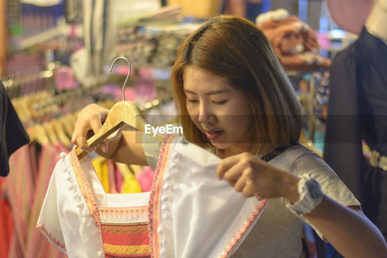 Woman choosing cloth at store