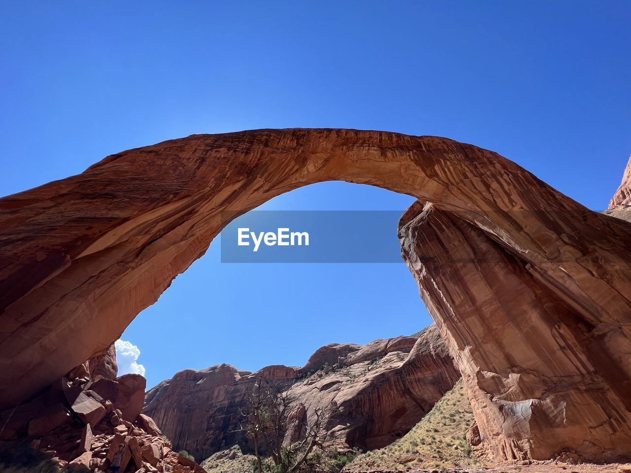 arch, rock, rock formation, sky, nature, scenics - nature, travel destinations, architecture, clear sky, natural arch, beauty in nature, environment, non-urban scene, landscape, geology, land, travel, no people, desert, tranquility, blue, physical geography, sunny, eroded, sunlight, day, outdoors, climate, mountain, tranquil scene, extreme terrain, idyllic, arid climate, dry, tourism, outdoor pursuit, semi-arid, sandstone, valley, remote