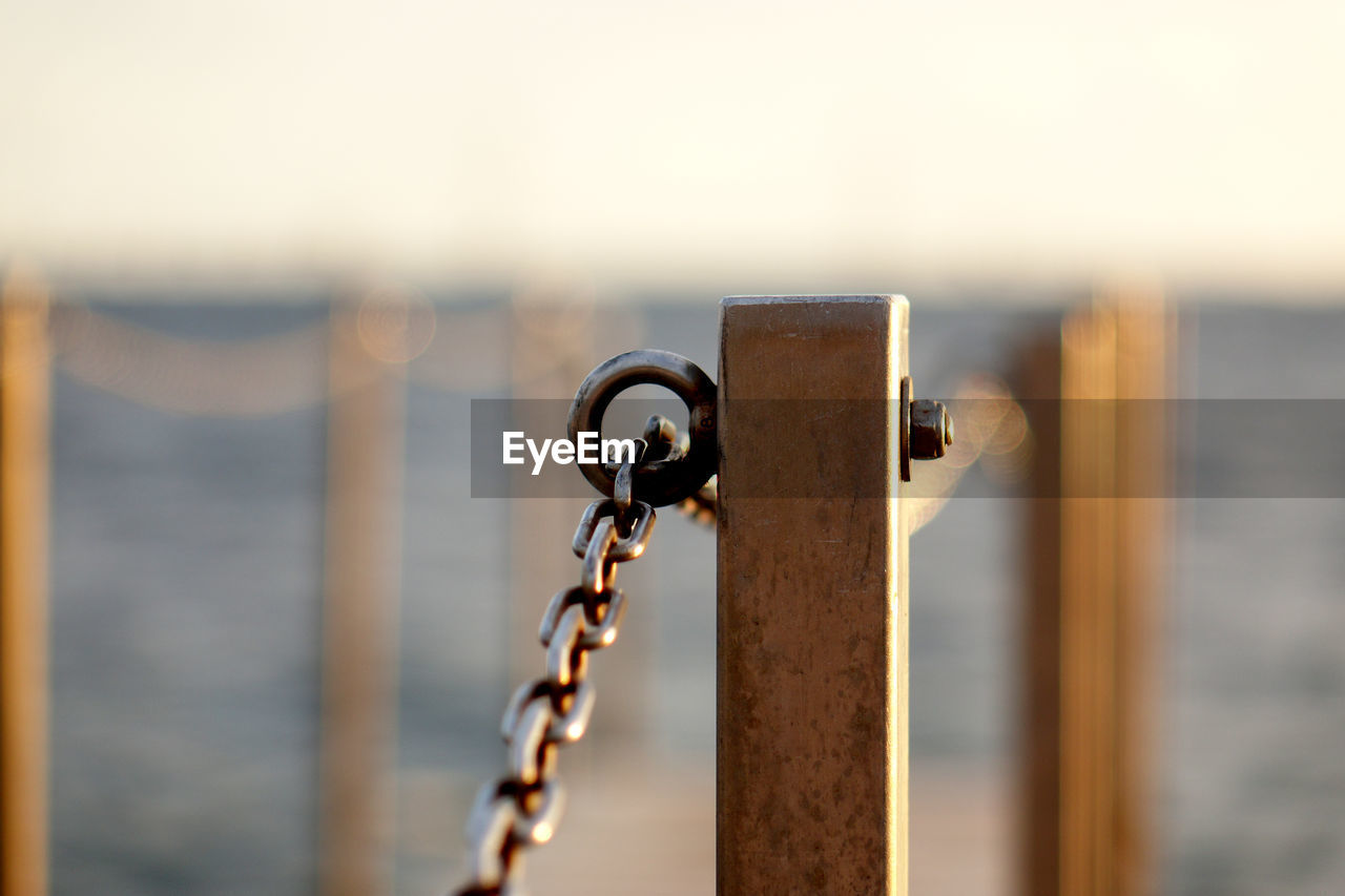 Close-up of chain railing at harbor