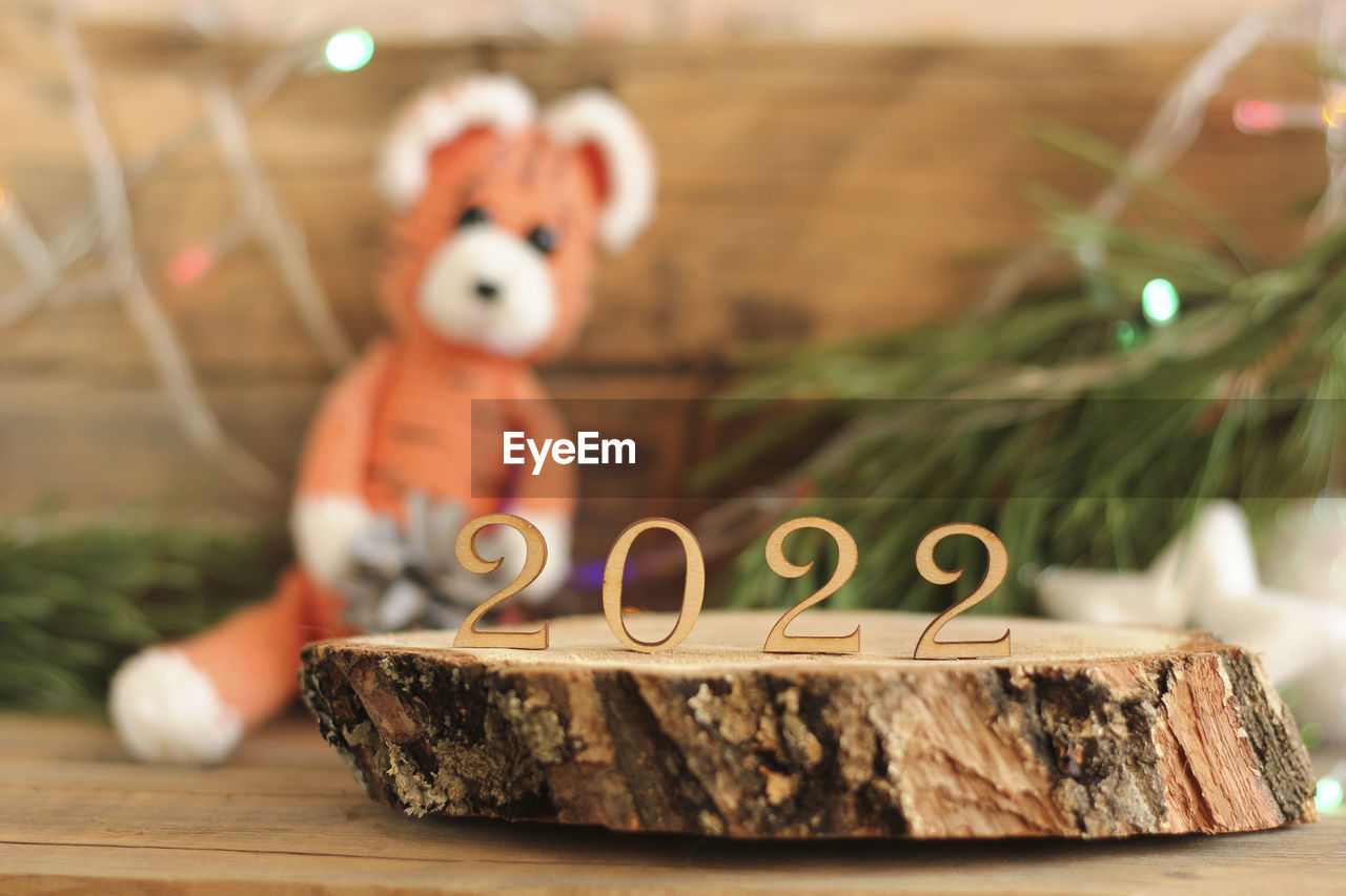 Numbers 2022 from wood on a wooden background in the background symbol of the new year tiger 