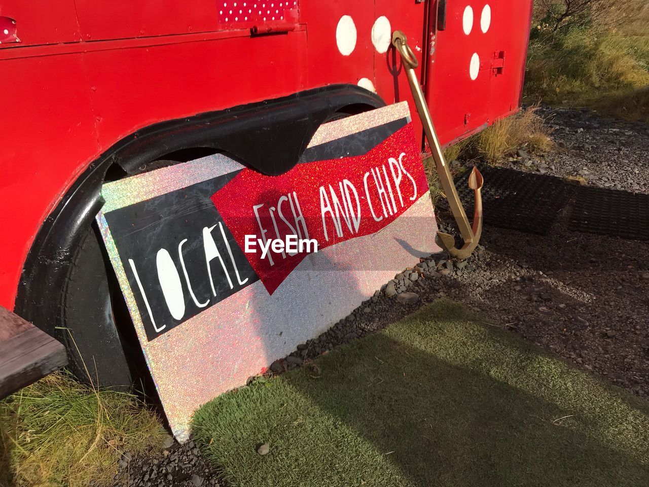 HIGH ANGLE VIEW OF TEXT ON OLD RED CAR