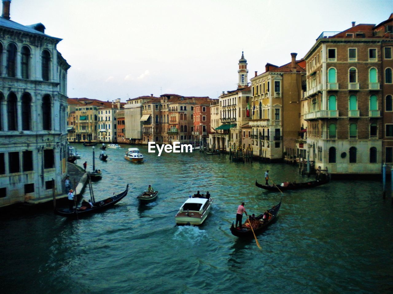 CANAL AMIDST BUILDINGS AGAINST SKY