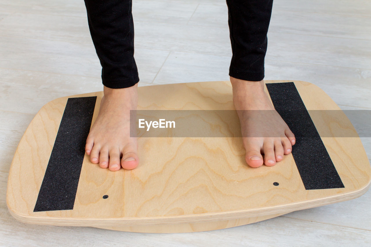 Low section of woman on balance board