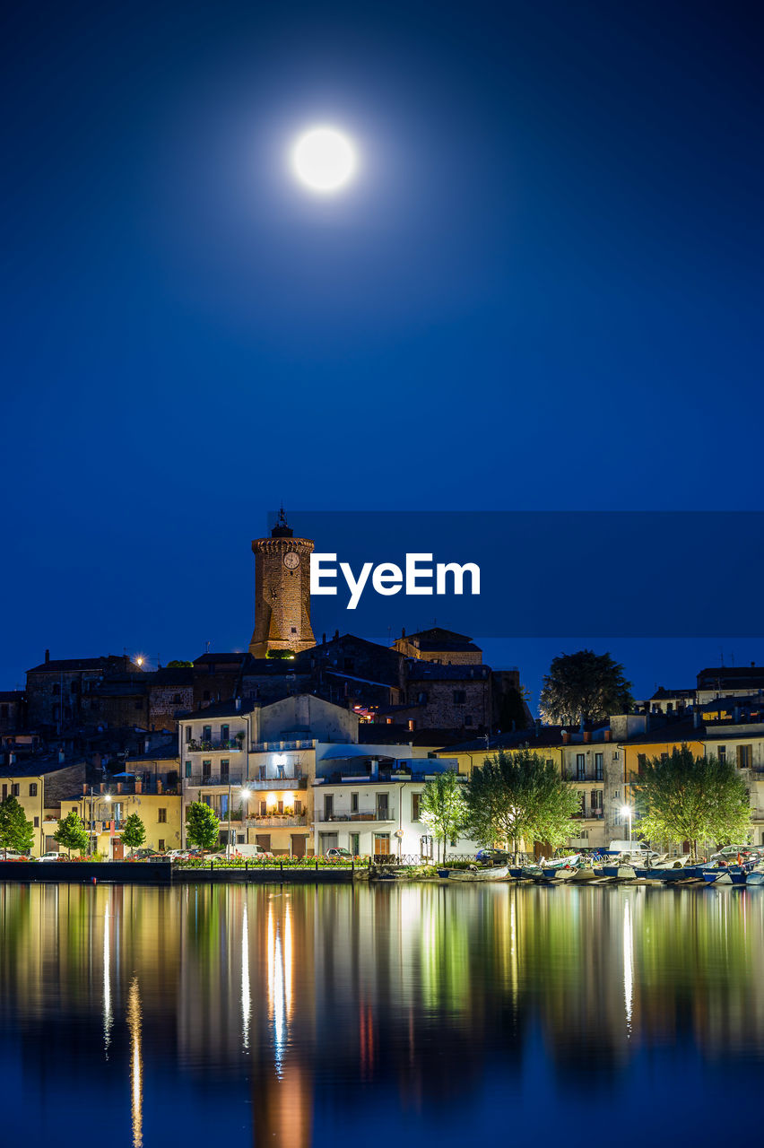 Nightview of the ancient village of marta, on the shore of bolsena lake in lazio, italy